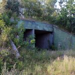 The entrance to a bunker structure at military ruins near Dębina, Poland.